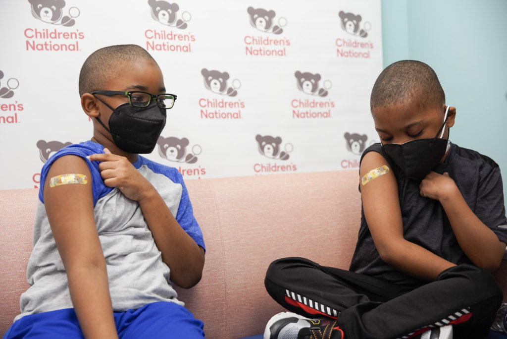 Children compare band-aids after receiving the COVID-19 vaccine at Children's National Hospital. | Photo: Children's National Hospital