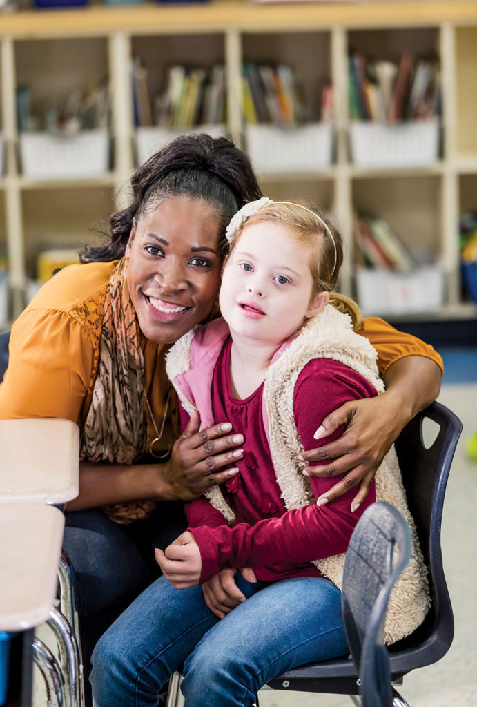 9-year-old girl with Down Syndrome with her elementary school teacher