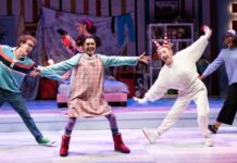 Three actors dance onstage