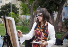 A woman painting outside