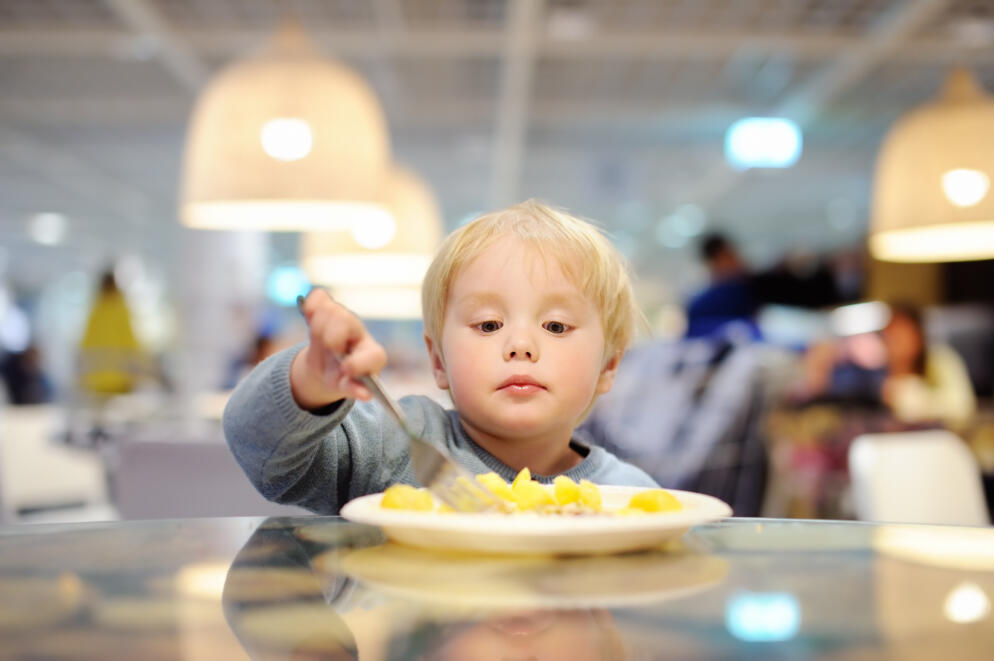 Toddler eating in a restaurant