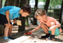 Two boys playing with toy shovels