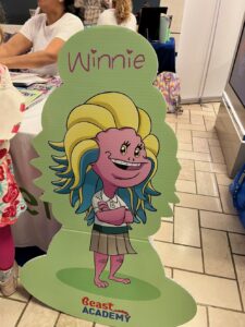 A cardboard cutout of a cartoon mascot