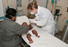 Ask the Expert: What To Know About Congenital Heart Defects A baby lying on a hospital bed receives a checkup from the doctor