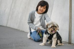 A child posing with a dog