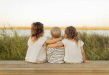 Three children sitting with their backs to the camera