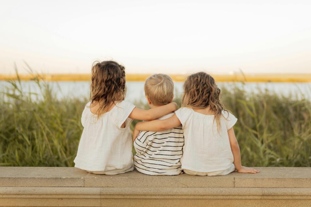Three children sitting with their backs to the camera