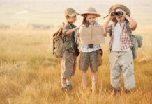 June: 5 Things for Families To Know in the DMV Group of kids travelers read a map at sunset