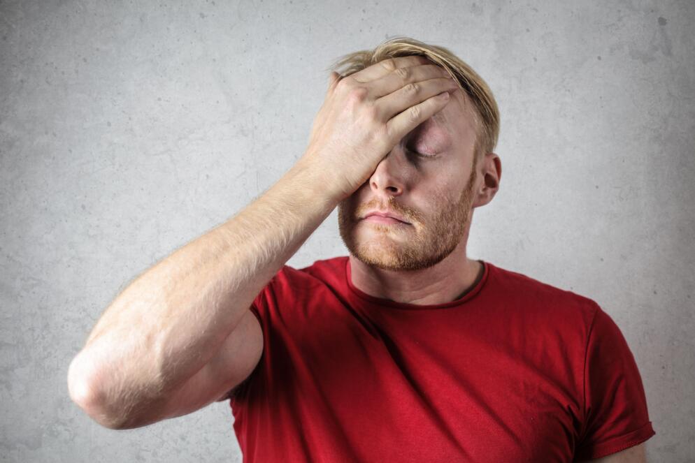 Man putting a hand on his forehead