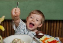 6 Things for Families To Know This Month in the D.C Area: August A young boy cheerfully enjoys healthy food at a restaurant.