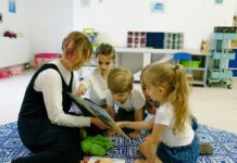 Readiness for Kindergarten: A Parent’s Guide to Basic Skills A teacher reads to three children in a classroom