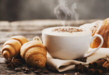 Hot coffee and pastries on a wooden background