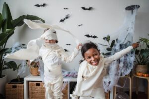 Two kids dressed as mummies