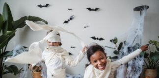 Two kids dressed as mummies